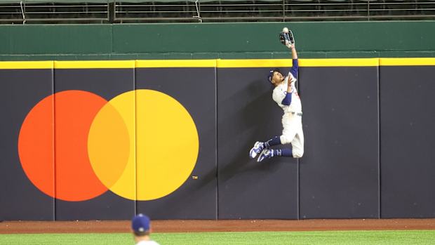 Oct 18, 2020; Arlington, Texas, USA; Los Angeles Dodgers right fielder Mookie Betts (50) makes a catch against Atlanta Braves right fielder Ronald Acuna Jr. (not pictured) in the fifth inning during game seven of the 2020 NLCS at Globe Life Field. Mandatory Credit: Kevin Jairaj-USA TODAY Sports